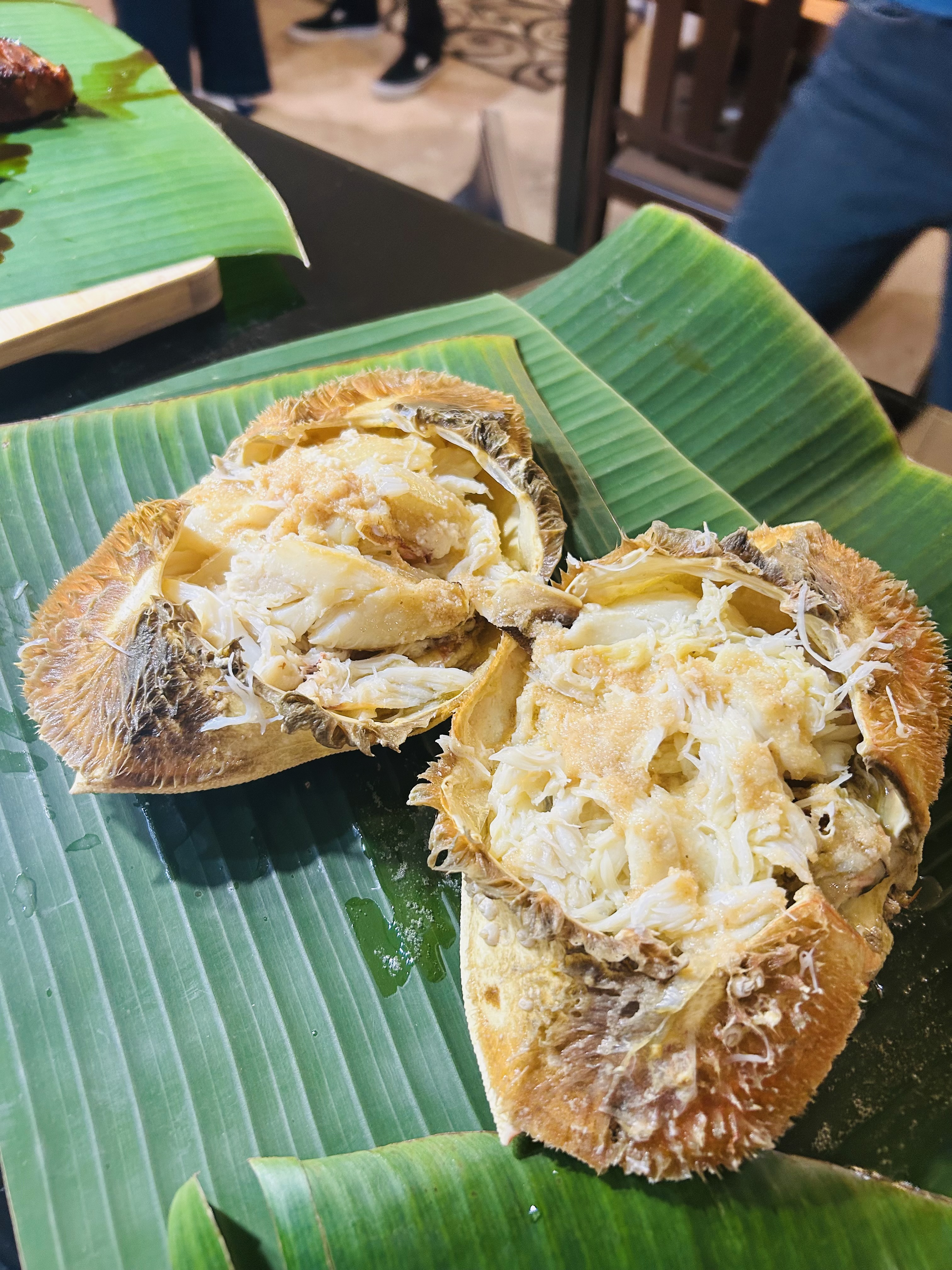 Roasted shareable dish presented on banana leaves